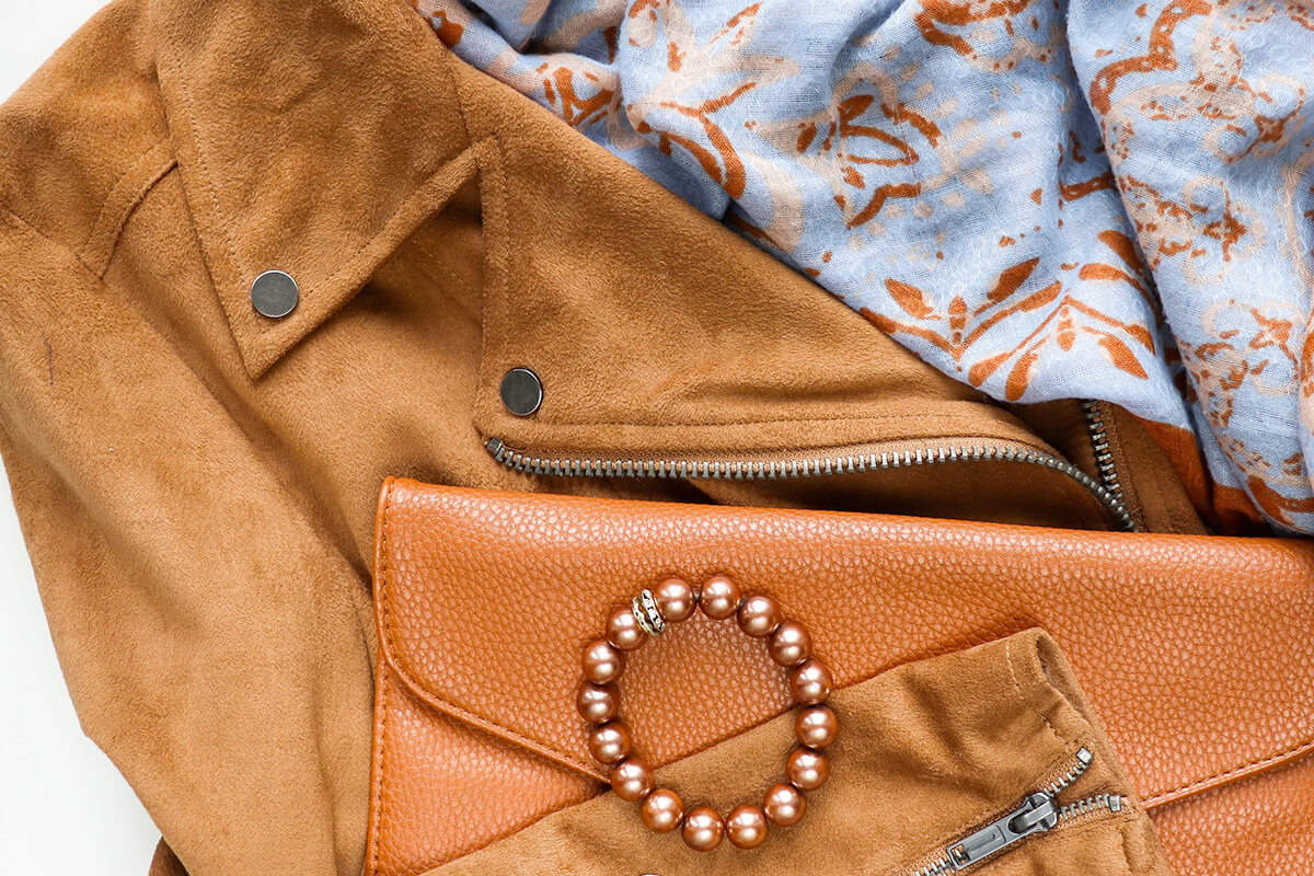 jackets and purses laying on a table